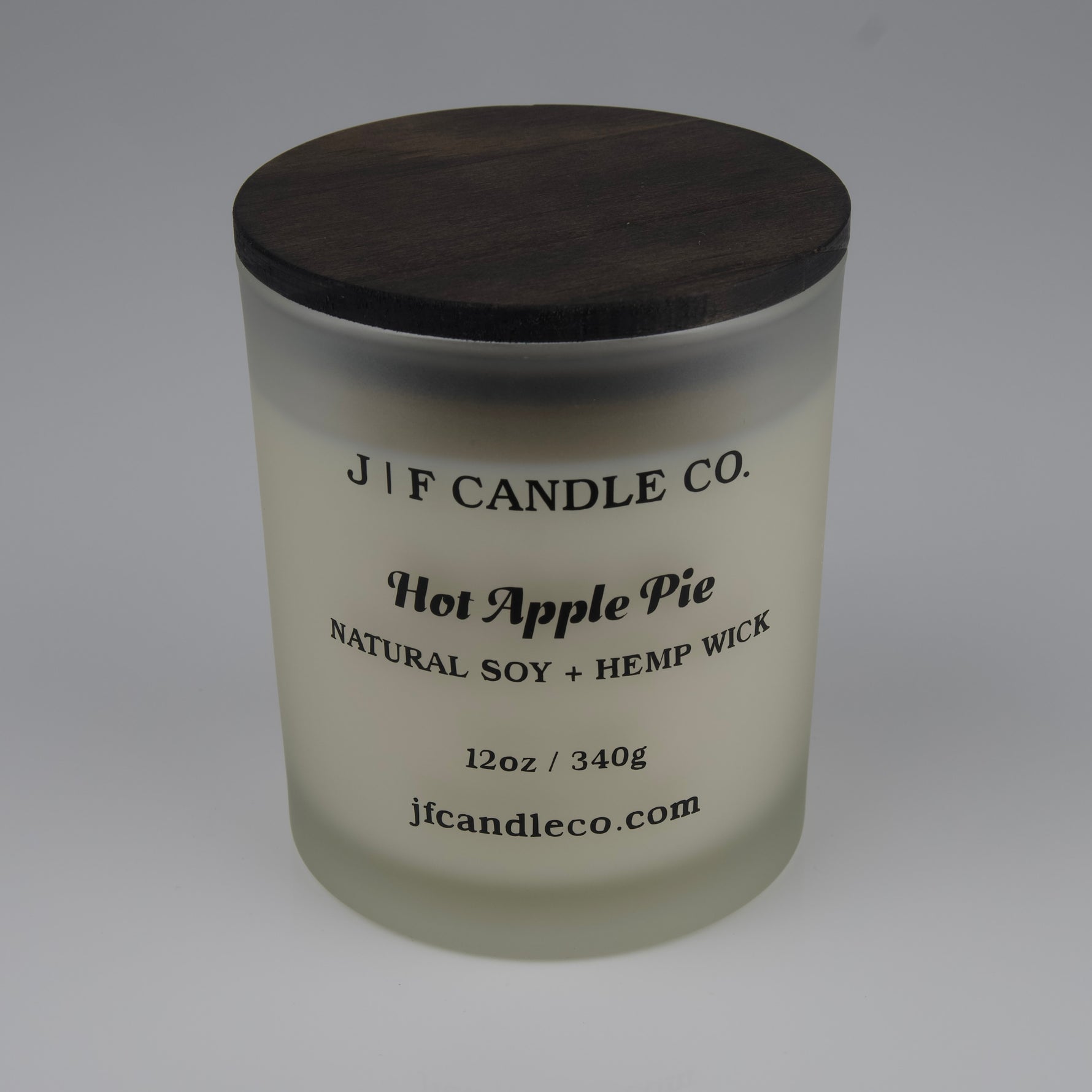 Hot Apple Pie Soy Candle by JF Candle Co. in a frosted glass jar with wooden lid, 12oz hand-poured natural soy wax with hemp wick.