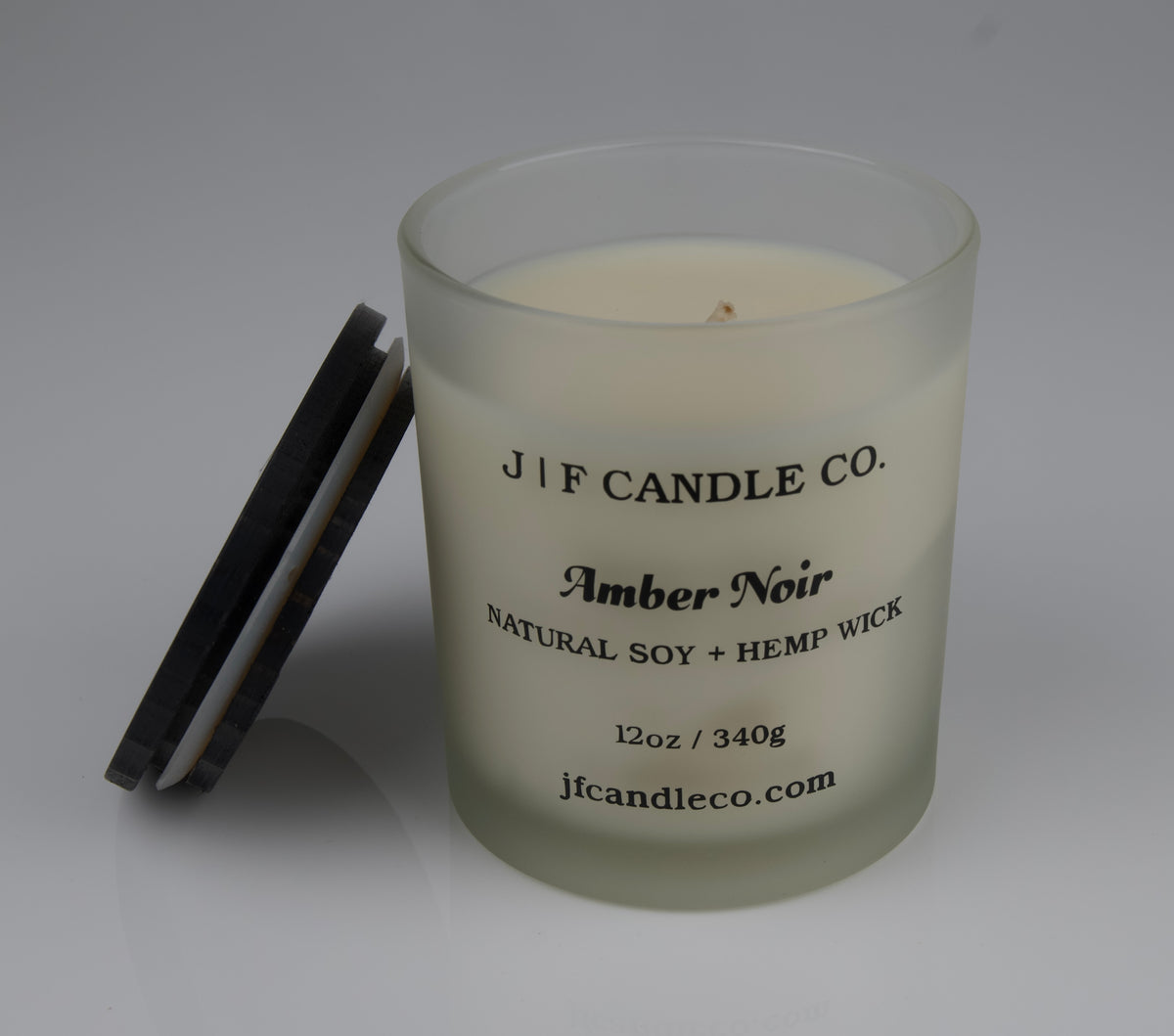 Amber Noir Frosted glass candle with 'JF Candle Co.' label