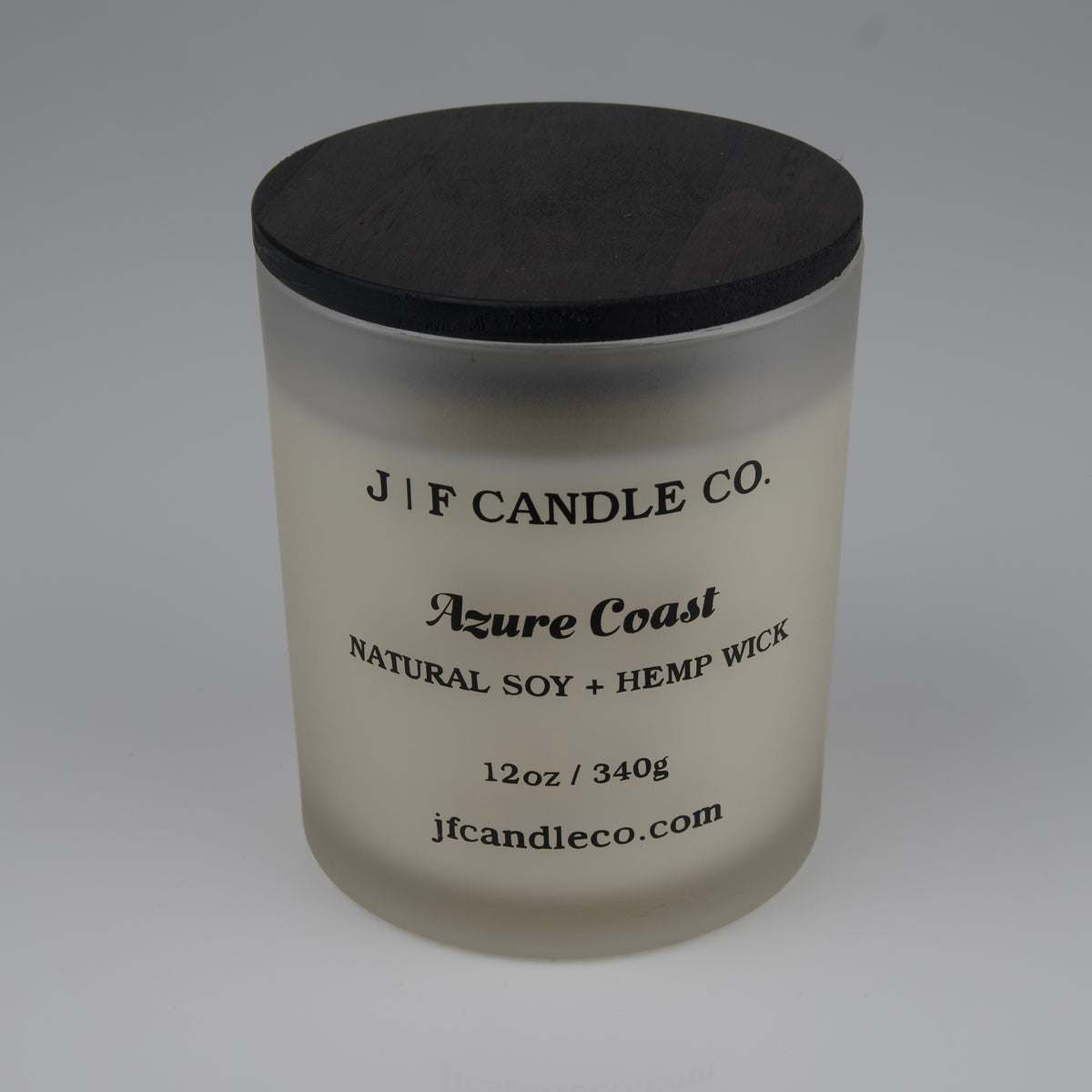 Frosted candle jar with black lid labeled 'J/F Candle Co. Azure Coast'