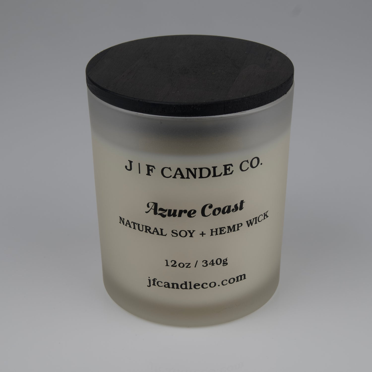Frosted candle jar with black lid labeled 'J/F Candle Co. Azure Coast'