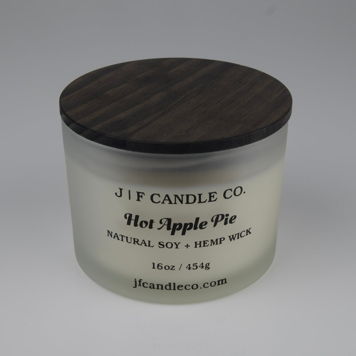 Hot Apple Pie Soy Candle by JF Candle Co. in a frosted glass jar with wooden lid, 16oz hand-poured natural soy wax with hemp wick.