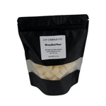 Black bag of JF Candle Co. Brandied Pear wax melts on a gray background
