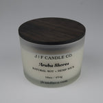 Candle jar with wooden lid labeled 'J/F Candle Co. Aruba Shores' 