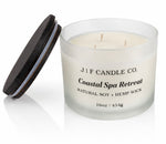 16oz Coastal Spa Retreat soy candle by J | F Candle Co. with three wicks in a frosted glass jar, wooden lid placed beside it on a clean white background.
