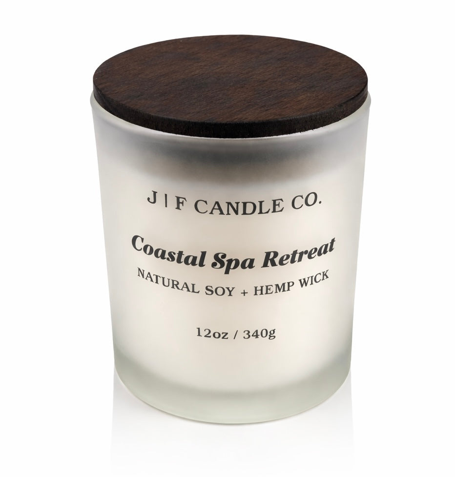 Coastal Spa Retreat soy candle by J | F Candle Co. in a frosted glass jar with a wooden lid, clean minimal product photo on a white background.