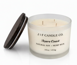 16 oz J | F Candle Co. Azure Coast soy candle in a frosted glass jar with three wicks and a wooden lid resting beside it, isolated on a clean white background with a soft reflective surface for a polished, luxury presentation.