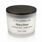 16 oz J | F Candle Co. Azure Coast soy candle in a frosted glass jar with a dark wood lid, clean studio background and soft base reflection