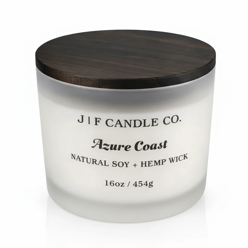 16 oz J | F Candle Co. Azure Coast soy candle in a frosted glass jar with a dark wood lid, clean studio background and soft base reflection