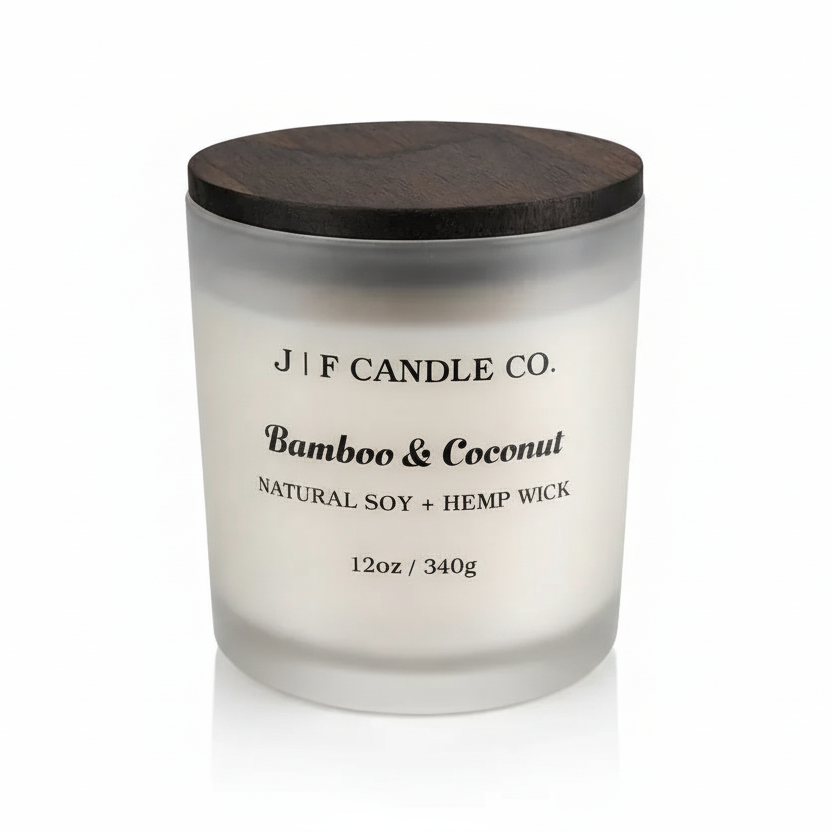 J F Candle Co Bamboo & Coconut soy candle in a frosted glass jar with wooden lid on a clean white background with soft reflection