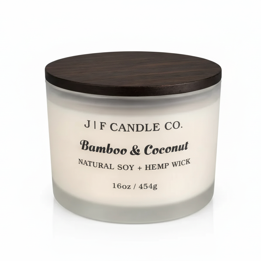 J F Candle Co Bamboo & Coconut 16 oz soy candle in a frosted glass jar with wooden lid on a clean white background with soft reflection