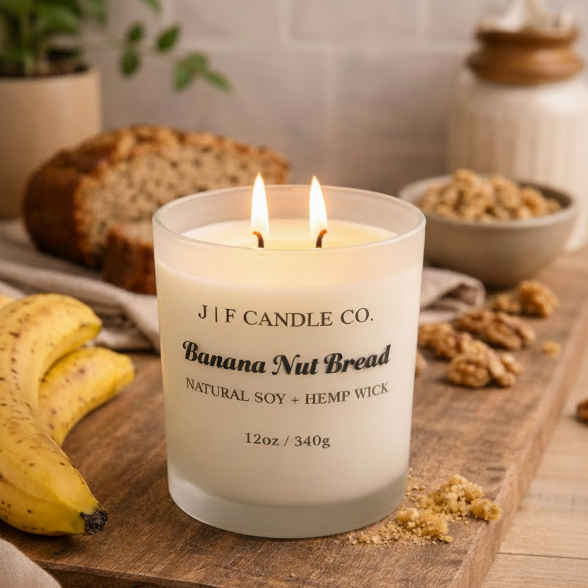 J | F Candle Co. Banana Nut Bread 12 oz natural soy candle lit with banana, walnut and fresh baked bread in warm cozy kitchen setting