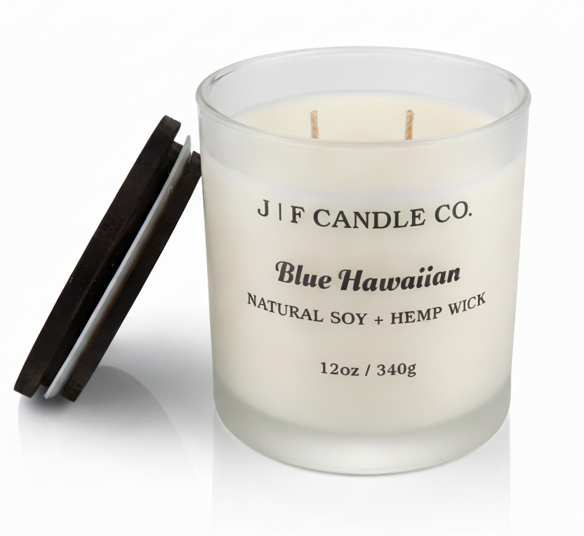 J | F Candle Co. Blue Hawaiian 12 oz luxury soy candle in frosted glass jar with wooden lid beside candle