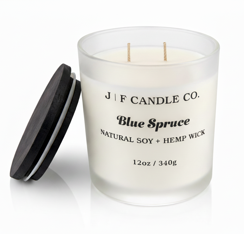 J | F Candle Co. Blue Spruce 12 oz natural soy candle in frosted glass jar with wooden lid resting on jar