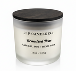 J | F Candle Co. Brandied Pear 16 oz natural soy candle in frosted glass jar with wooden lid on clean white background