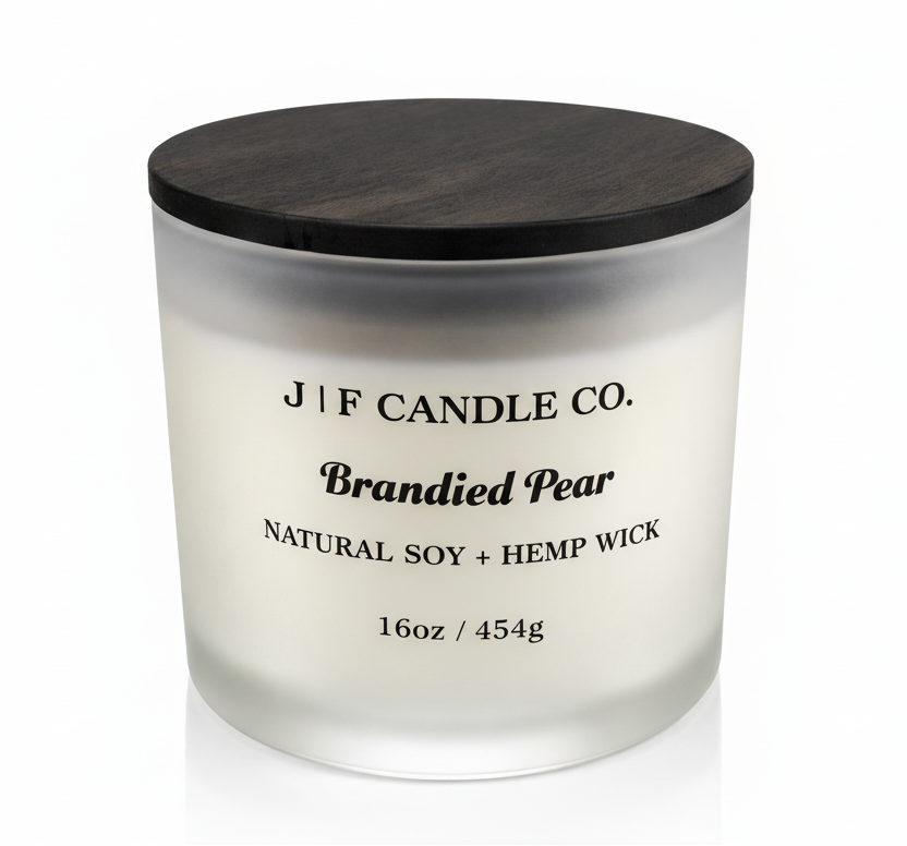 J | F Candle Co. Brandied Pear 16 oz natural soy candle in frosted glass jar with wooden lid on clean white background