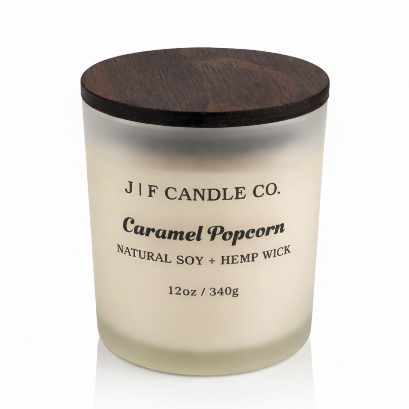 J | F Candle Co. Caramel Popcorn 12 oz natural soy candle in frosted glass jar with wooden lid and soft reflection on clean white background
