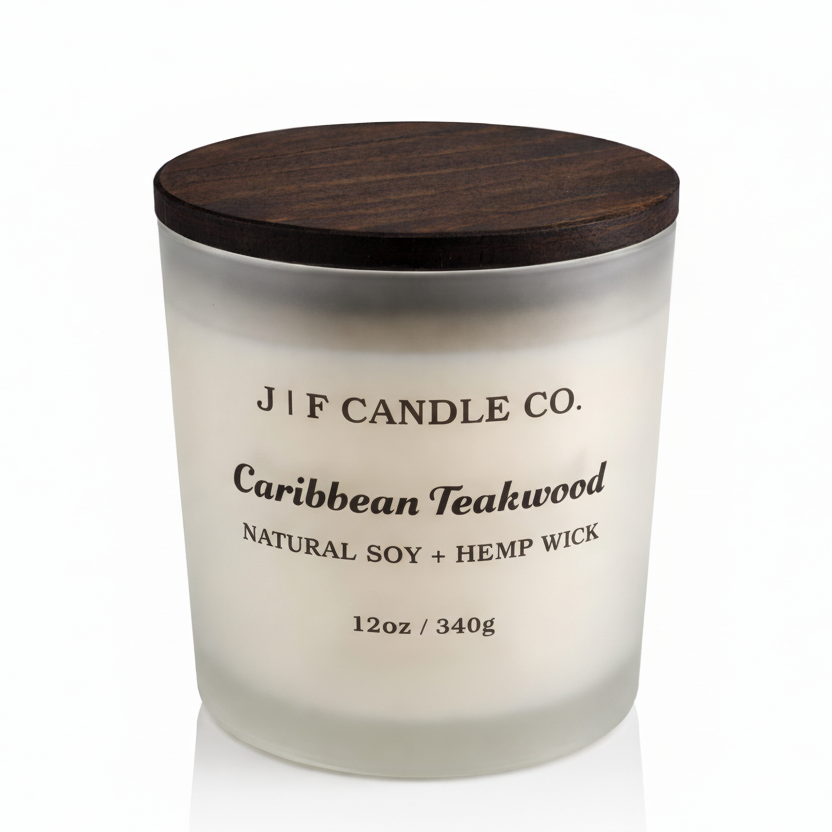 J | F Candle Co. Caribbean Teakwood 12 oz natural soy candle in frosted glass jar with wooden lid on and soft reflection on clean white background