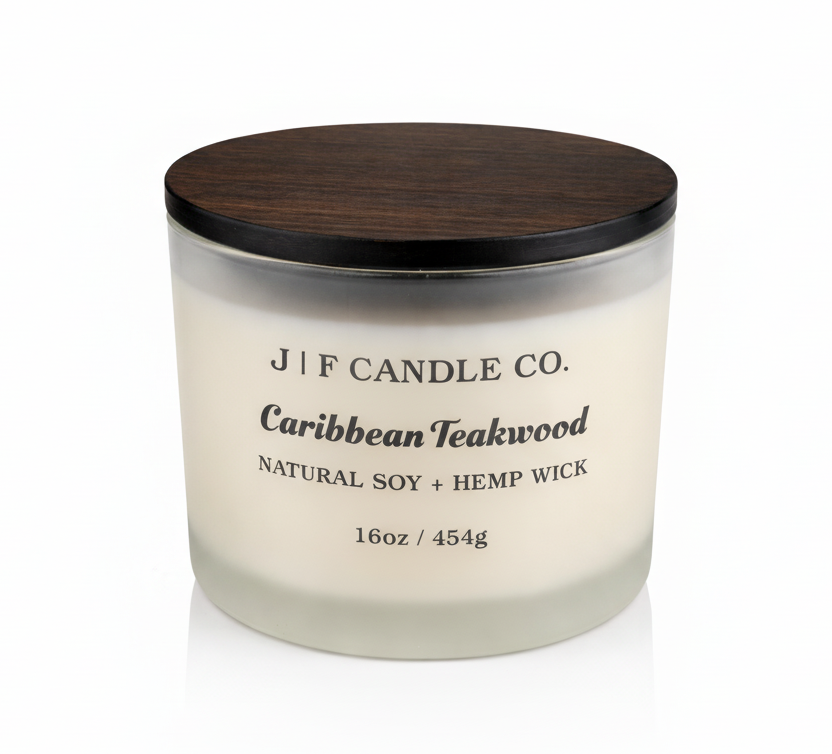 J | F Candle Co Caribbean Teakwood 16 oz soy candle in frosted glass jar with wooden lid on clean white background with soft reflection