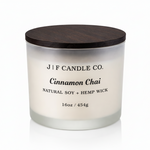 J | F Candle Co. Cinnamon Chai 16oz soy candle in frosted glass jar with wooden lid on clean white background with soft reflection