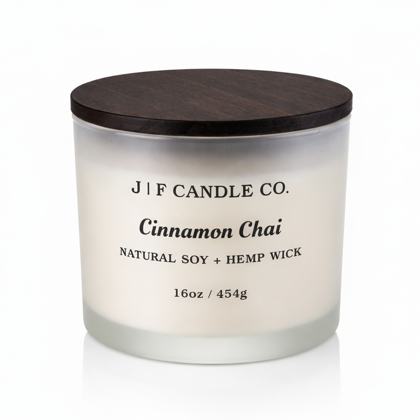 J | F Candle Co. Cinnamon Chai 16oz soy candle in frosted glass jar with wooden lid on clean white background with soft reflection