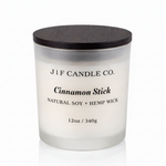 J | F Candle Co. Cinnamon Stick 12oz soy candle in frosted glass jar with wooden lid on a clean white background with soft reflection