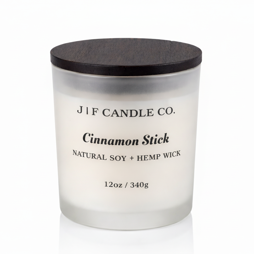J | F Candle Co. Cinnamon Stick 12oz soy candle in frosted glass jar with wooden lid on a clean white background with soft reflection