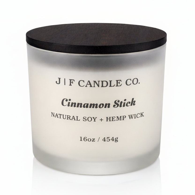J | F Candle Co. Cinnamon Stick 16oz soy candle in frosted glass jar with wooden lid on a clean white background with soft reflection
