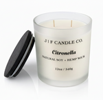 J | F Candle Co. Citronella 12oz soy candle in frosted glass jar with wooden lid placed beside it on a clean white background with soft reflection
