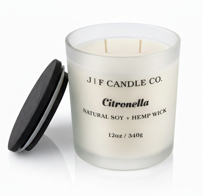 J | F Candle Co. Citronella 12oz soy candle in frosted glass jar with wooden lid placed beside it on a clean white background with soft reflection