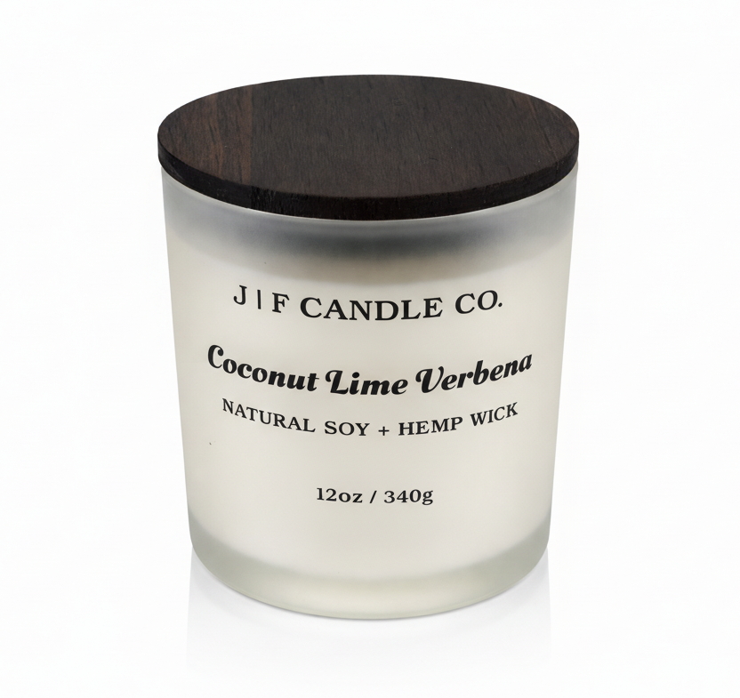 J | F Candle Co. Coconut Lime Verbena 12oz soy candle in frosted glass jar with wooden lid on a clean white background with soft reflection