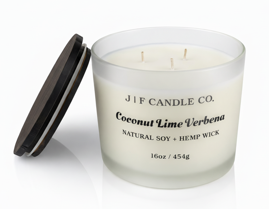 J | F Candle Co. Coconut Lime Verbena 16oz three-wick soy candle in frosted glass jar with wooden lid on clean white background with soft reflection
