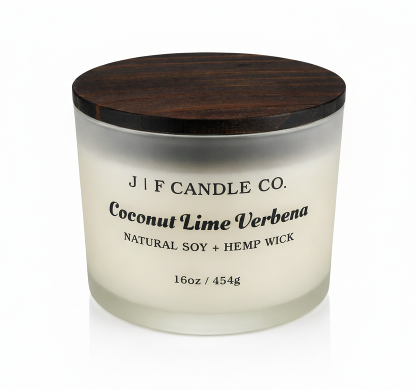 J | F Candle Co. Coconut Lime Verbena 16oz soy candle in frosted glass jar with wooden lid on a clean white background with soft reflection