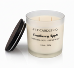 J | F Candle Co Cranberry Apple 12oz soy candle in frosted glass jar with wooden lid removed on clean white background