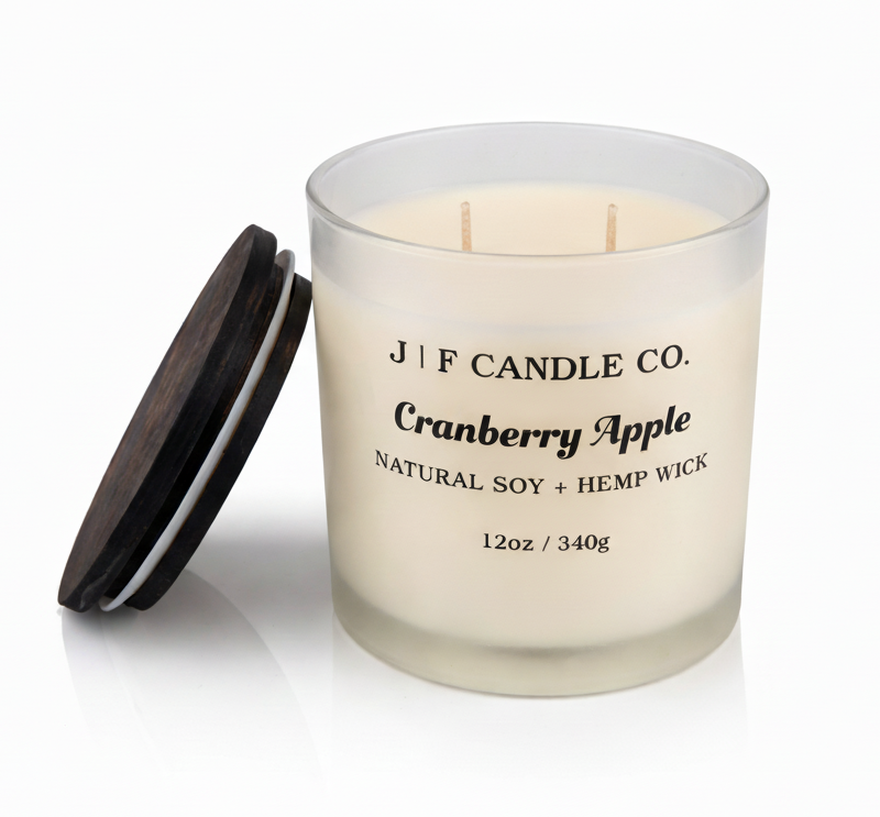 J | F Candle Co Cranberry Apple 12oz soy candle in frosted glass jar with wooden lid removed on clean white background