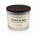 J | F Candle Co Cranberry Apple 16oz soy candle in frosted glass jar with wooden lid on white background with soft reflection
