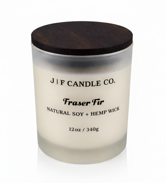 J | F Candle Co Fraser Fir 12oz soy candle in frosted glass jar with wooden lid on white background with soft reflection