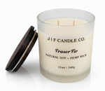 J | F Candle Co Fraser Fir 12oz soy candle in frosted glass jar with wooden lid beside candle on white background