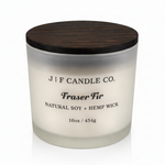 J | F Candle Co Fraser Fir 16oz soy candle in frosted glass jar with wooden lid on white background with soft reflection