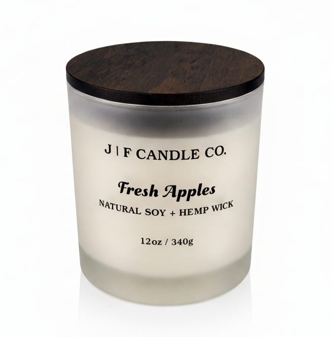 J | F Candle Co Fresh Apples 12oz soy candle in frosted glass jar with wooden lid on white background with soft reflection