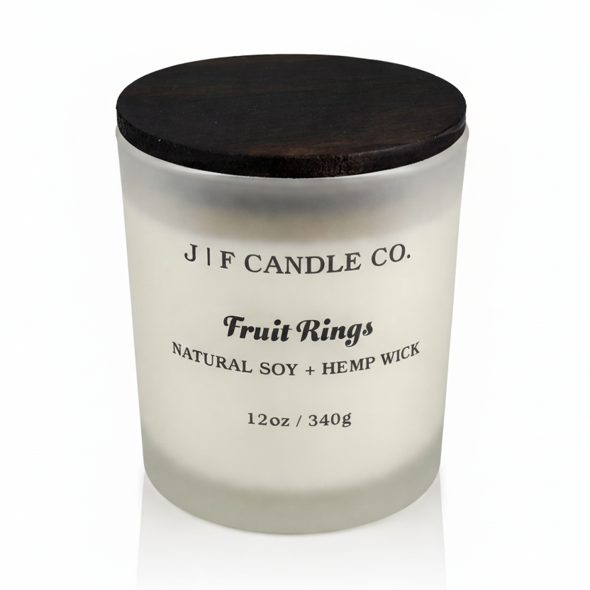 J | F Candle Co. Fruit Rings luxury soy candle with wooden lid in frosted glass jar on clean white background with soft reflection, 12oz