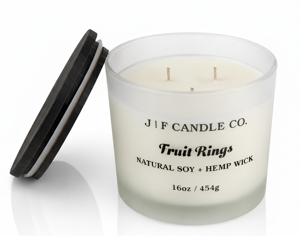 J | F Candle Co. Fruit Rings luxury soy candle 16oz with lid off and double wicks in frosted glass jar on clean white background with soft reflection