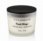 J | F Candle Co. Fruit Rings luxury soy candle 16oz in frosted glass jar with wooden lid on clean white background with soft reflection