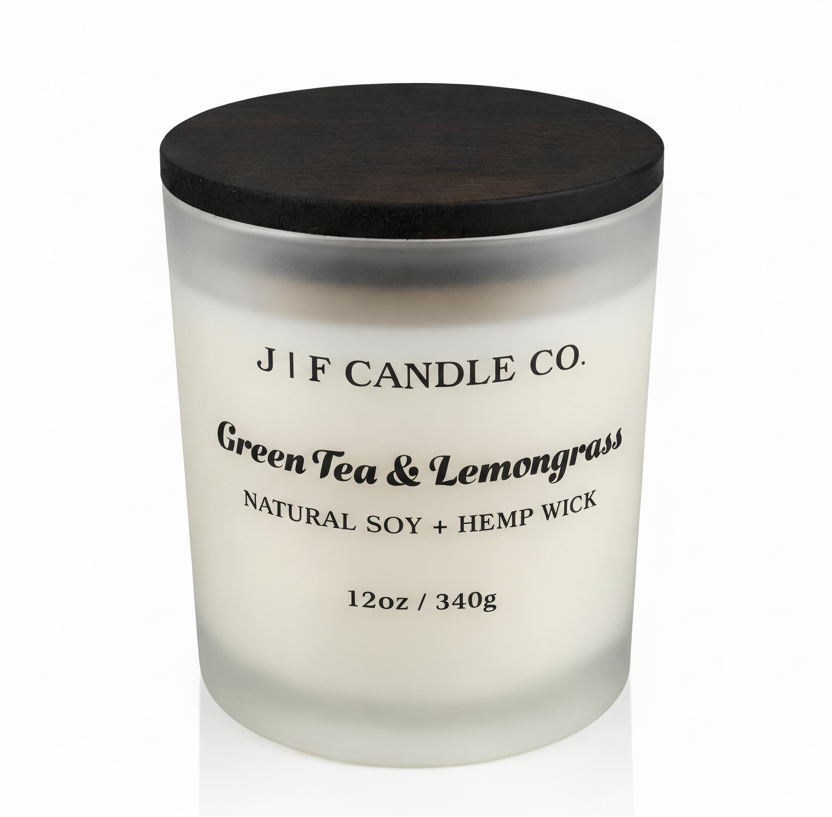J | F Candle Co. Green Tea & Lemongrass luxury soy candle in frosted glass jar with wood lid, clean white background and soft reflection, 12oz