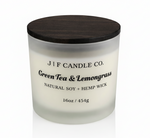 J | F Candle Co. Green Tea & Lemongrass luxury soy candle in 16oz frosted glass jar with wood lid, clean white background and soft reflection