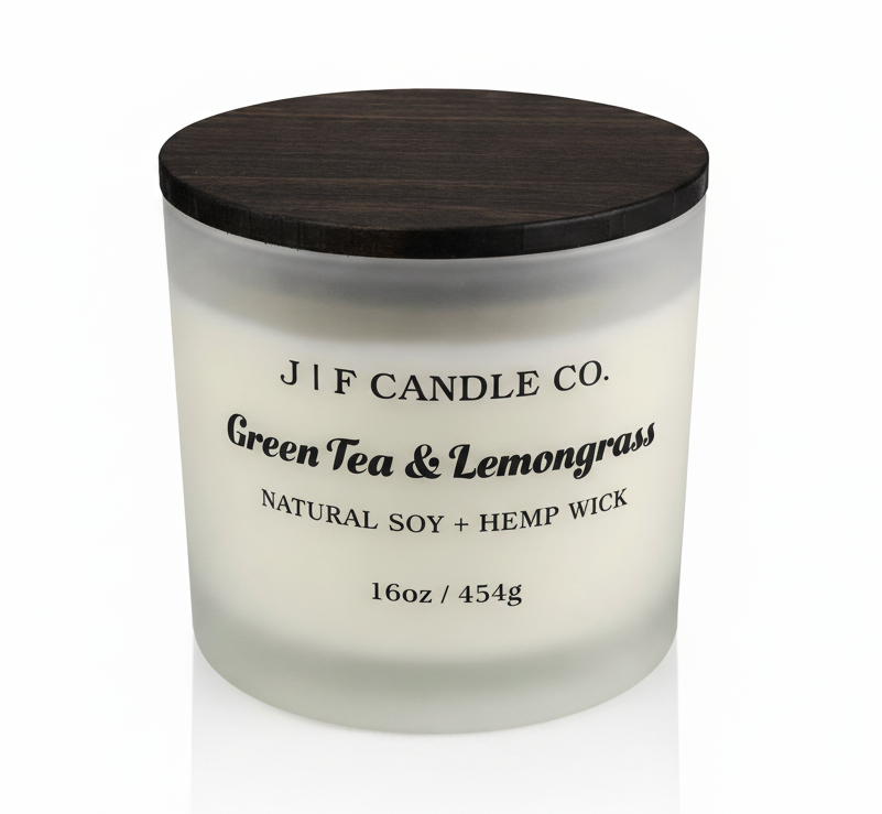 J | F Candle Co. Green Tea & Lemongrass luxury soy candle in 16oz frosted glass jar with wood lid, clean white background and soft reflection