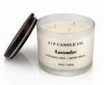 Lavender soy candle with three wicks in frosted glass jar with wooden lid beside candle, clean-burning natural soy wax with hemp wicks by J | F Candle Co, 16oz luxury candle with soft reflection