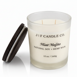 J | F Candle Co Mint Mojito luxury soy candle with open wooden lid beside jar, frosted glass container on clean white background with soft reflection, 12 oz