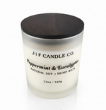 J | F Candle Co Peppermint & Eucalyptus soy candle in 12oz frosted glass jar with wooden lid, clean white background and soft reflection, luxury spa-inspired scent