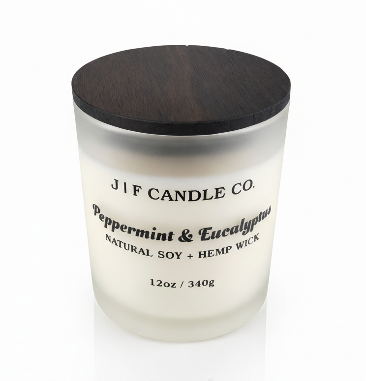 J | F Candle Co Peppermint & Eucalyptus soy candle in 12oz frosted glass jar with wooden lid, clean white background and soft reflection, luxury spa-inspired scent