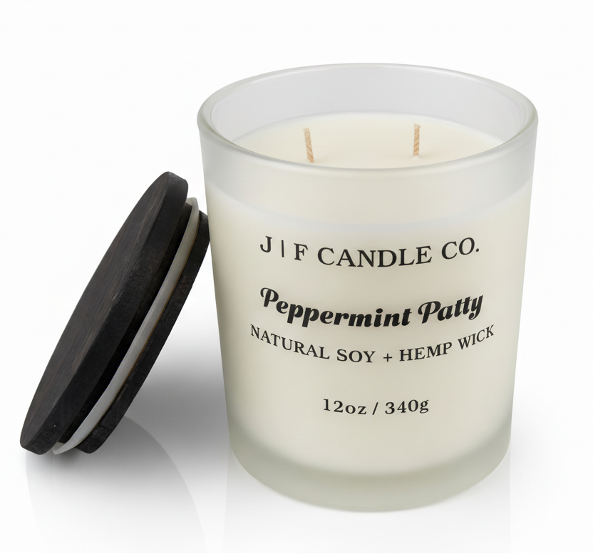 J | F Candle Co Peppermint Patty 12oz soy candle in frosted glass jar with wooden lid beside candle, clean white background with soft reflection, mint chocolate fragrance candle